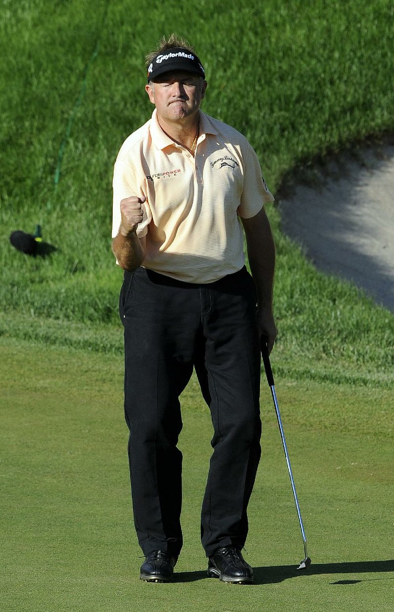 Ken Duke of Arkadelphia (above) celebrates after sinking a birdie putt on the second playoff hole at the Travelers Championship on Sunday. It was Duke’s first PGA Tour victory. 