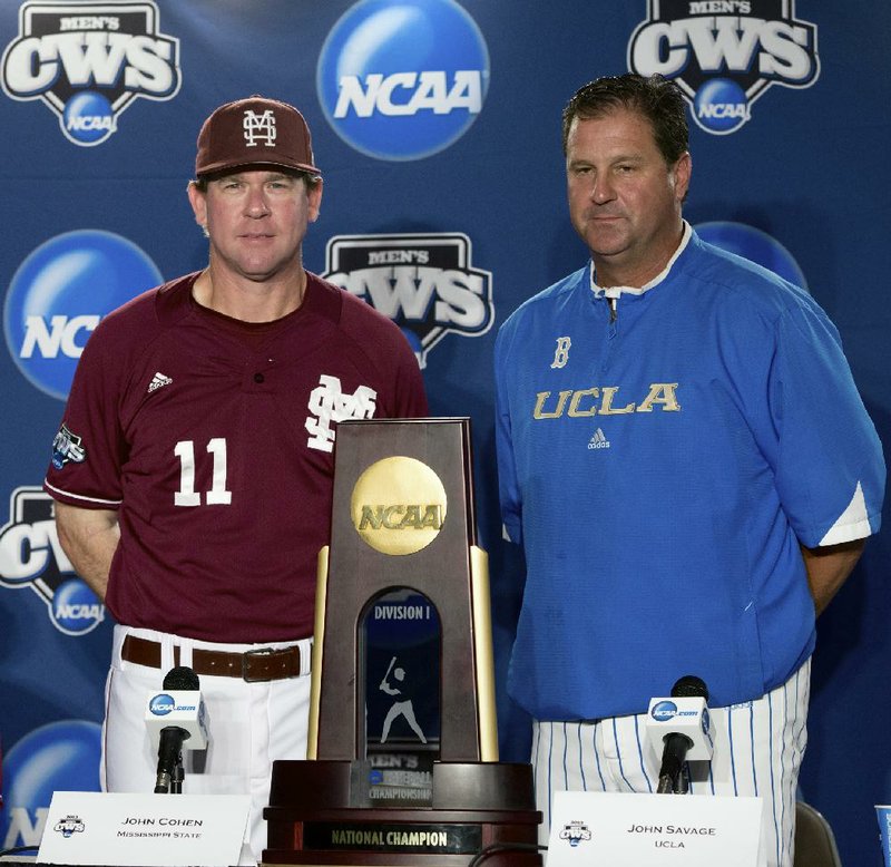 Mississippi State Coach John Cohen (left) and UCLA Coach John Savage pose with the College World Series trophy before a news conference Sunday at TD Ameritrade Park in Omaha, Neb. Both teams will play in the best-of-three championship series beginning tonight. 