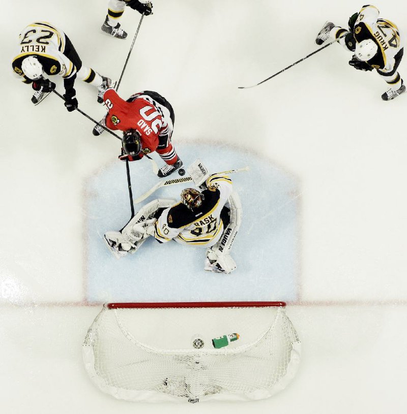 Boston Bruins goalie Tuukka Rask (40) blocks a shot by Chicago’s Brandon Saad (20) in the third period of the Blackhawks’ 3-1 victory Saturday night in the Stanley Cup final in Chicago. Boston hosts Chicago in Game 6 tonight with the Blackhawks leading the series 3-2 and needing one more victory to win its second Stanley Cup title in four seasons. 