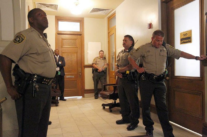 Pulaski County sheriff’s deputies guard the courtroom door while jurors ask Judge Wendell Griffen a question during deliberations Sunday in the manslaughter trial of former Little Rock police officer Josh Hastings. 