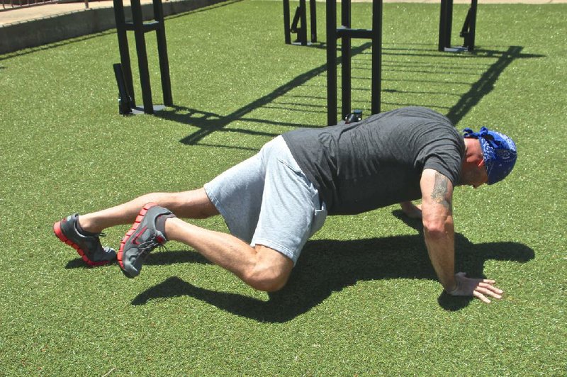 When standard push-ups become tediously easy, David Chappell shakes things up by lifting one knee toward an elbow, which increases the difficulty. But before you advance to this Spider Push-up, Matt Parrott says, be able to do at least six simpler push-ups on your toes. 