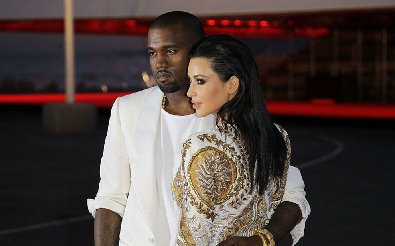 Singer Kanye West, left, and television personality Kim Kardashian arrive for the screening of Cruel Summer at the 65th international film festival, in Cannes, southern France, Wednesday, May 23, 2012. (AP Photo/Francois Mori)