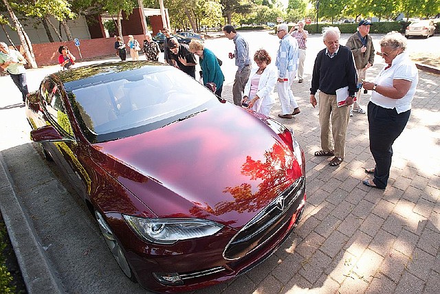 Tesla shareholders look at a Model S sedan after the Tesla Motors Inc. annual meeting in Mountain View, Calif., on June 4. 
