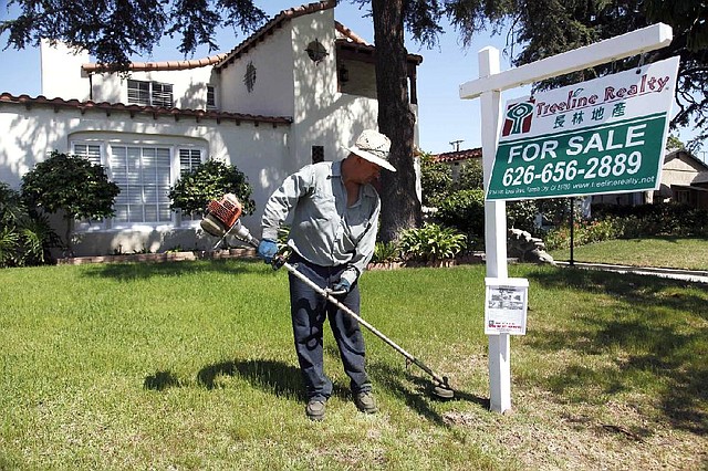 A gardener trims the lawn of a house for sale in Alhambra, Calif., in May. U.S. home prices rose 12.1 percent in April, compared to April 2012. 