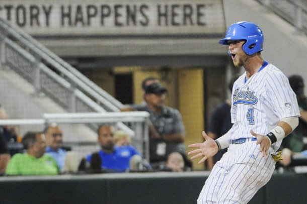 UCLA's Eric Filia celebrates as he scored in the seventh inning of an NCAA College World Series baseball game in Omaha, Neb. UCLA beat Mississippi State 8-0 in the title-clinching game, but tied the record for sacrifice bunts in a College World Series with 12 (AP Photo/Francis Gardler).