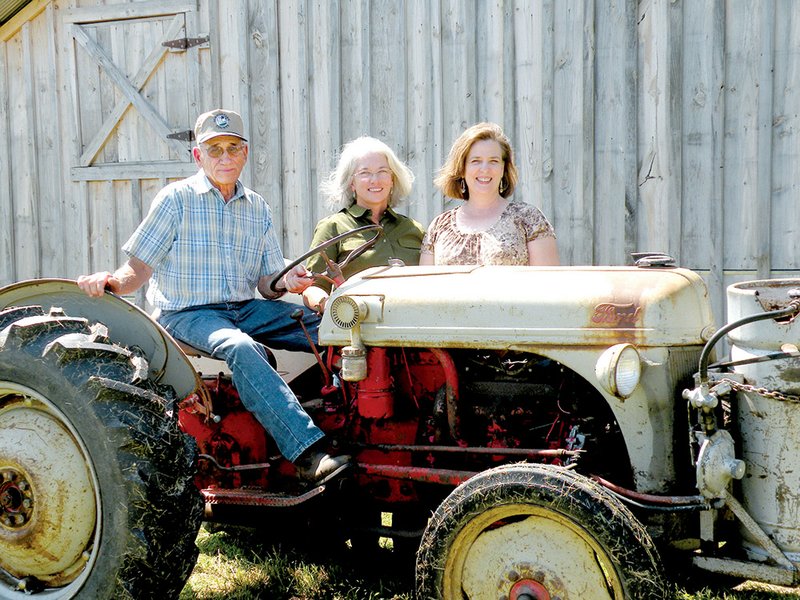 Hugh Eldridge taught his daughters, Janice Irwin, center, and Sandra Andrews, to drive this 1941 Ford tractor before they could drive a car. 
