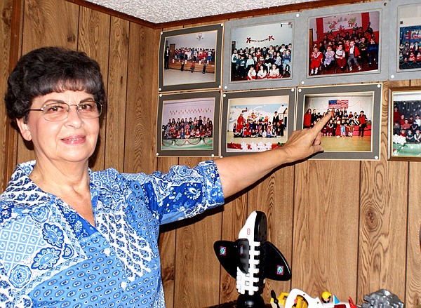 Evelyn Wilmoth points to many of the photos of children she has cared for in the past 40 years. 