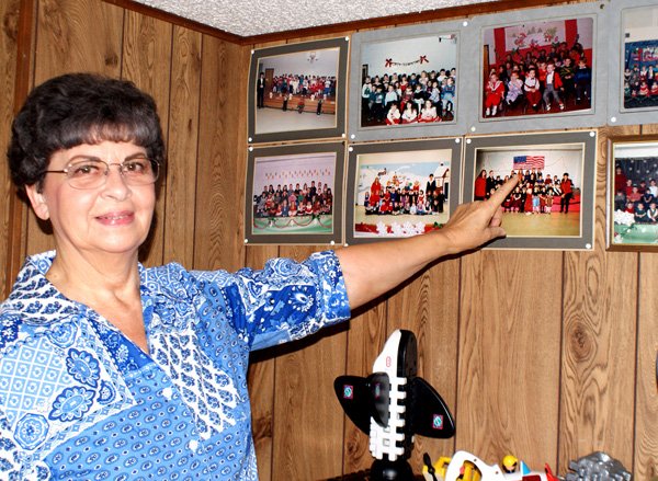 Evelyn Wilmoth points to many of the photos of children she has cared for in the past 40 years. 