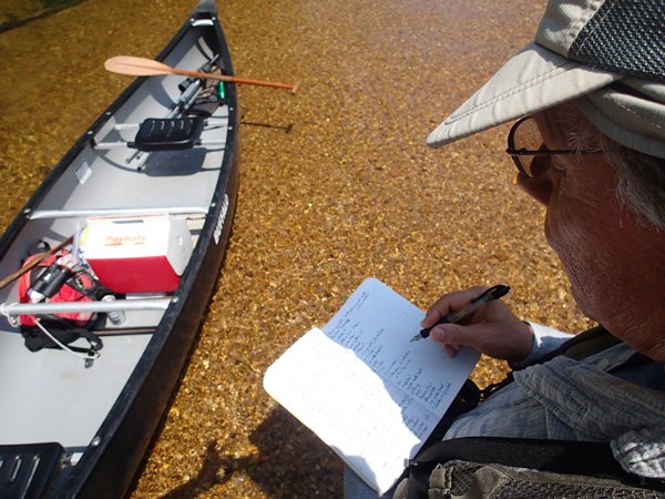 A notebook helps Joe Neal keep track of the birds he sees on birding trips. Neal also makes notes for writing descriptive essays about his trips for birders on a group email list. 