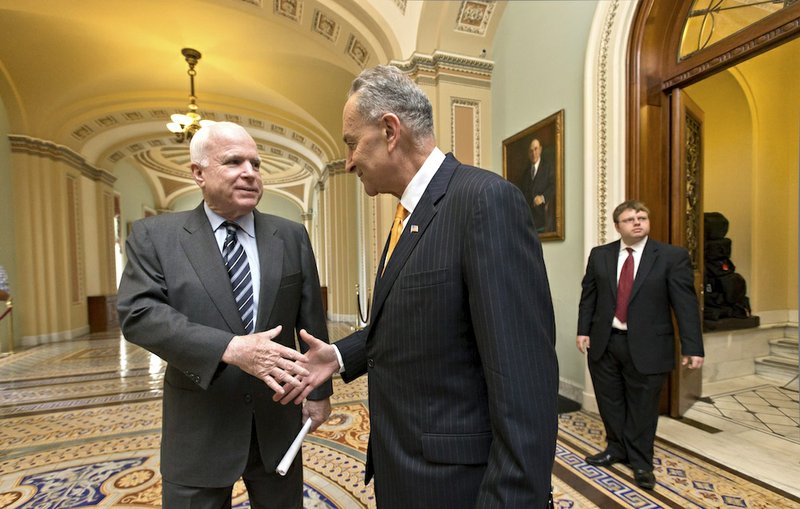 Sen. John McCain, R-Ariz., left, and Sen. Charles Schumer, D-N.Y., right, two of the authors of the immigration reform bill crafted by the Senate's bipartisan "Gang of Eight," shakes hands on Capitol Hill in Washington, Thursday, June 27, 2013, before the final vote. The legislation would dramatically remake the U.S. immigration system and require a tough new focus on border security. 