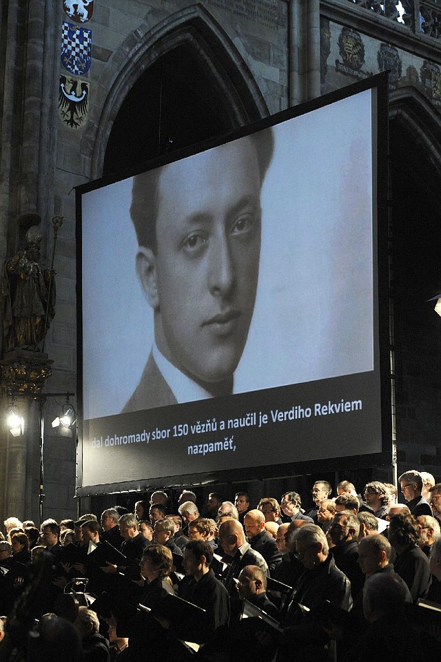 An image of Rafael Schachter is projected onto a screen during a performance of the Giuseppe Verdi's Requiem Mass at St. Vitus Cathedral in Prague, Czech Republic on Thursday, June 6, 2013. The Roman Catholic Mass was played in memory of the young musician and his fellow musicians who perished in the Terezin concentration camp, among them composers, artists and intellectuals from across Europe.