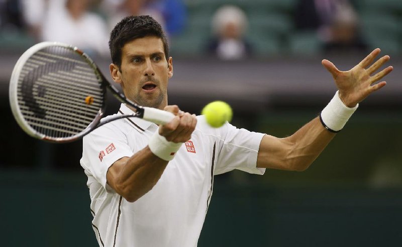 Novak Djokovich of Serbia returns to Bobby Reynolds of the United States during his second-round victory at Wimbledon on Thursday. 