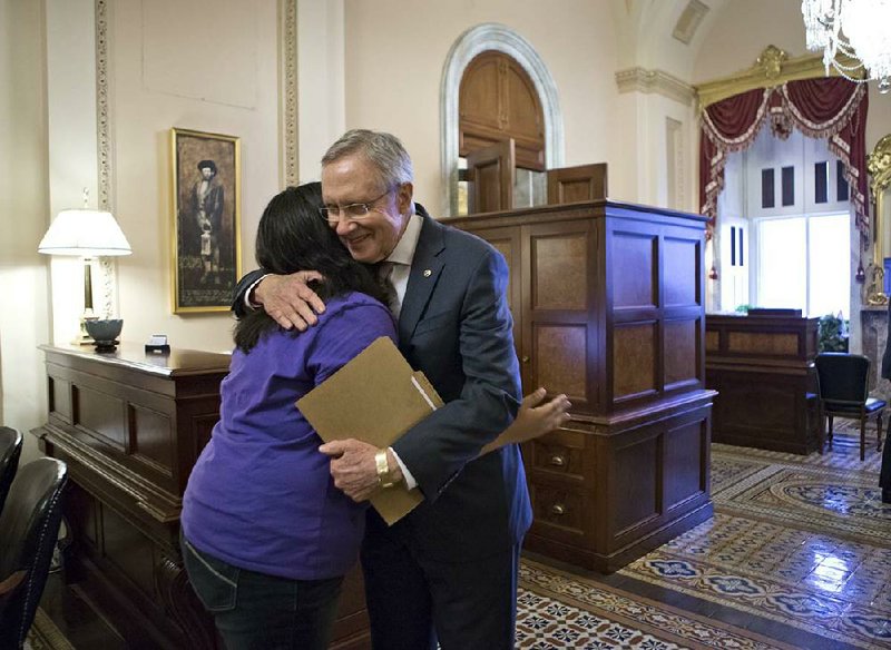 Senate Majority Leader Harry Reid, D-Nev., embraces Astrid Silva of Las Vegas on Thursday at the Capitol. Silva’s family came to the U.S. from Mexico illegally, and Reid says her story has served as an inspiration during his work on immigration. Reid read letters from Silva on the Senate floor before Thursday’s vote. 