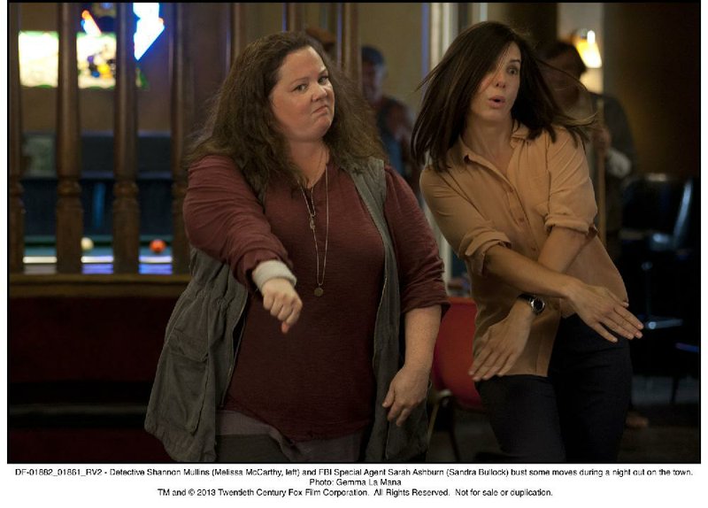 Sisters are doing it for themselves. The unlikely team of police detective Mullins (Melissa McCarthy) and FBI agent Ashburn (Sandra Bullock) employ some unusual investigative techniques in The Heat. 