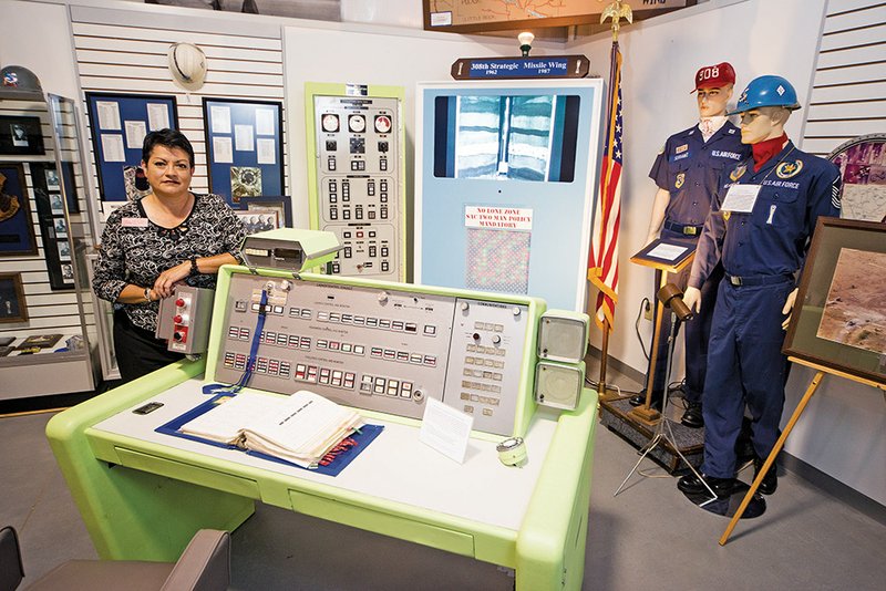 DannaKay Duggar, director of the Jacksonville Museum of Military History, is shown with one of the newest additions to the displays, a Titan II missile-launch control panel. The museum will host the U.S. Army Adventure simulators on Friday.