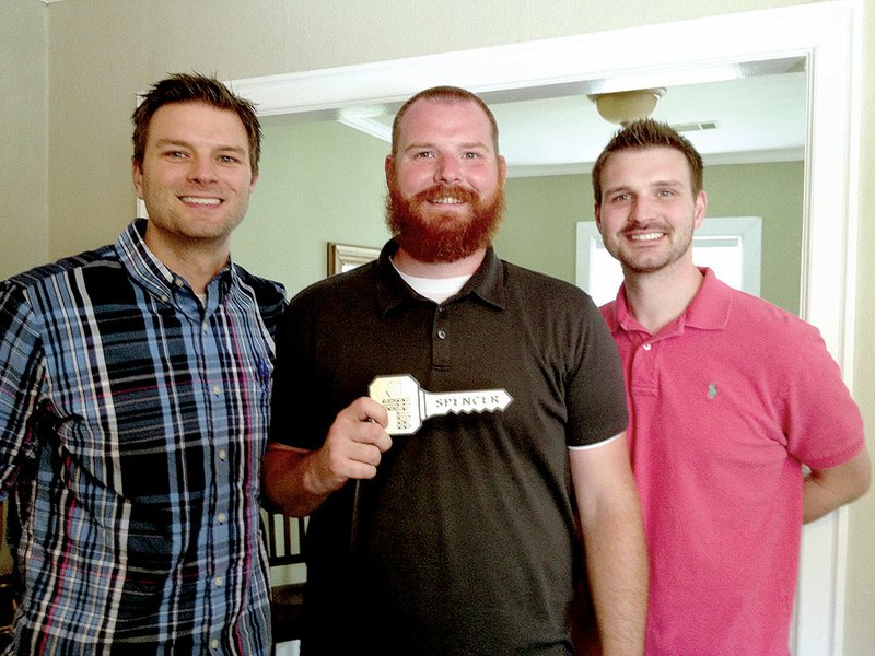 Spencer Clawson of Conway, center, holds the key to the Big Brother house, which symbolizes that he was accepted as a cast member for the 15th season of the reality show. Also pictured are his brothers, Chuck, left, and Grant. Chuck said Spencer took some University of Central Arkansas and Wampus Cat shirts to wear on the show. An interview with Spencer is available at CBS.com.