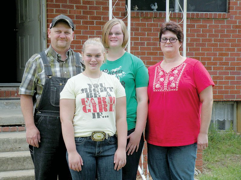 The Terry Brown family of the Bexar community is the 2013 Fulton County Farm Family of the Year. Family members include, front row, Sydney Brown; and back row, from the left, Terry Brown, Savannah Brown and Becky Brown. The family  raises registered Gelbvieh cattle, as well as hogs, laying hens and hay.