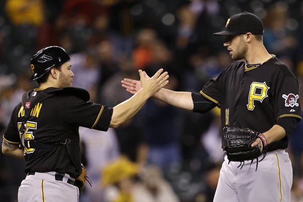 Pittsburgh Pirates catcher Russell Martin, left, and pitcher Duke Welker congratulate each other after the team beat the Seattle Mariners in a baseball game Tuesday, June 25, 2013, in Seattle. The Pirates won 9-4. (AP Photo/Elaine Thompson)