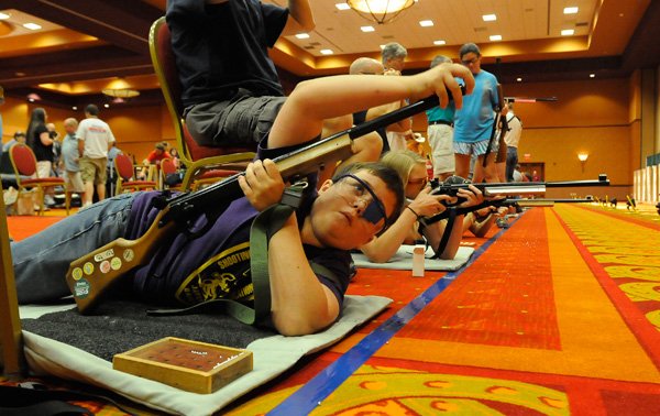 Blake Shephard, a competitor from Tennessee, loads his air rifle before a practice round Friday during the Daisy National BB Gun Championship Match. 