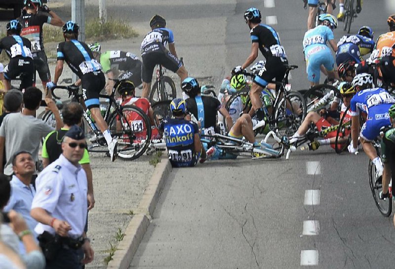 Two-time Tour de France winner Alberto Contador of Spain (91) sits on the road after a group of about 20 riders fell near the end of the first stage. Contador, who had a bruised and cut shoulder, finished the race. 