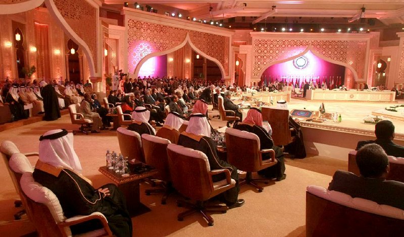At the behest of a Qatar official, Syrian opposition representatives sit in seats reserved for Syria during an Arab League summit in March in Doha, Qatar. Qatar has been instrumental in getting weapons to Syrian rebels, U.S. officials say. 