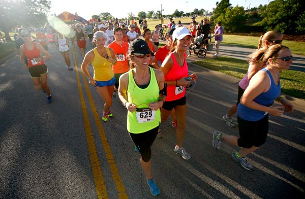 Runners take off Saturday to start the annual Cancer Challenge 10K at Orchards Park in Bentonville.