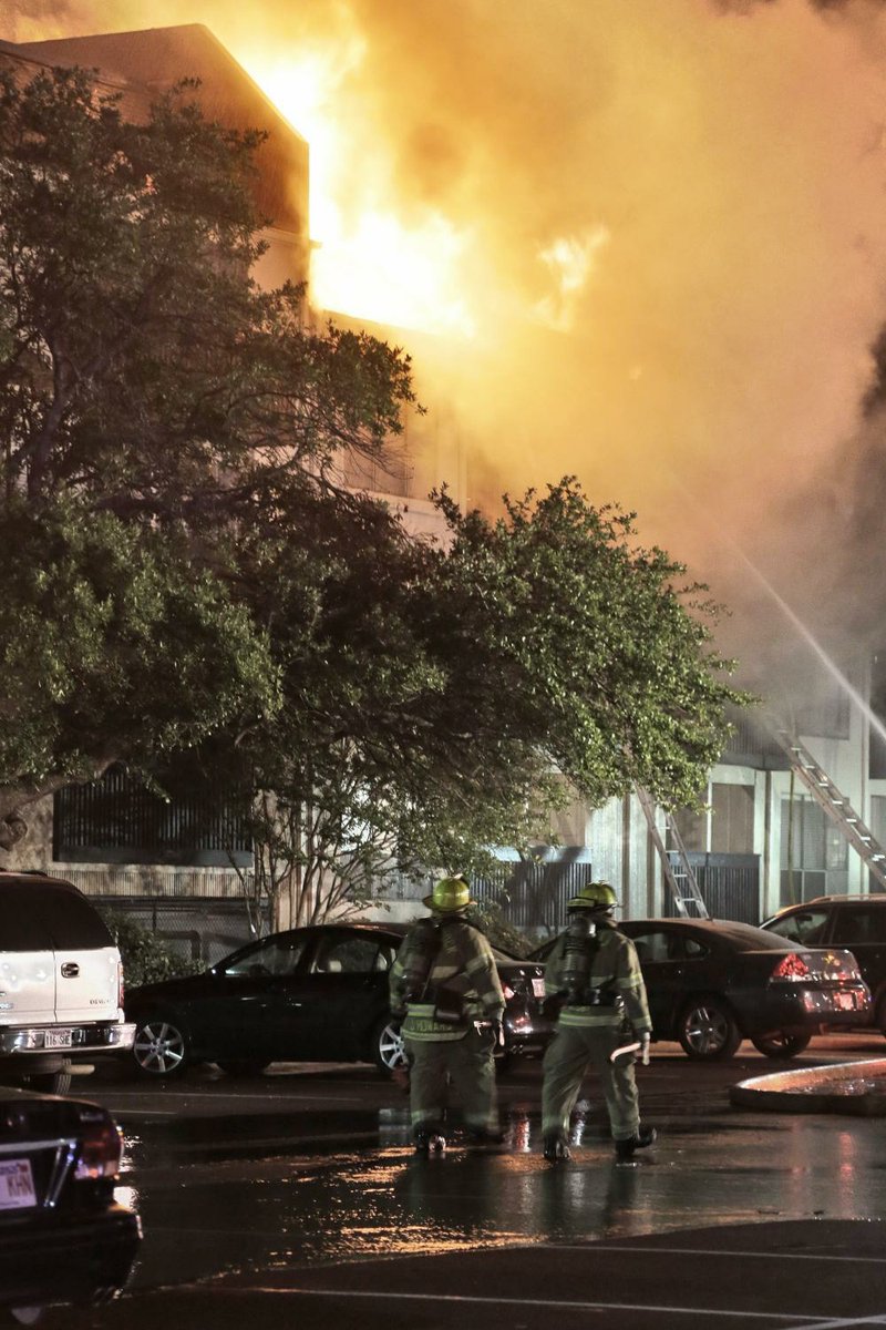 Little Rock firefighters work at a large-scale fire May 16 at Forest Place Apartments at 1421 N. University Ave.