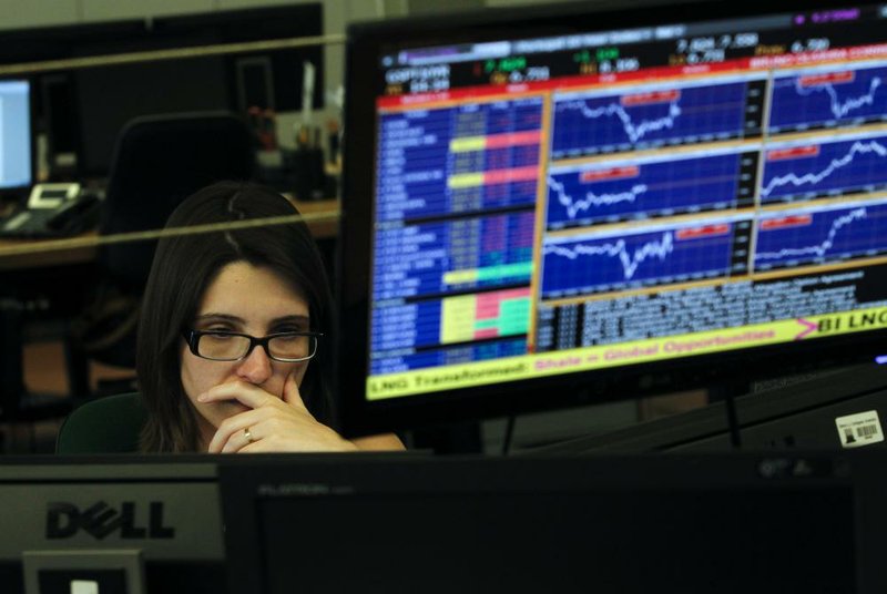 A broker works Wednesday in the trading room of a Portuguese bank in Lisbon. Portugal’s financial markets nose-dived Wednesday as the government neared collapse. 