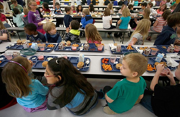 Students at lunch March 14 at Root Elementary School in Fayetteville. Fayetteville School District is appealing to to eligible families to register their children for free and reduced-price meals. 