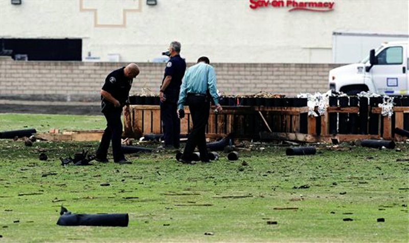 Police officials investigate a site in Simi Valley, Calif., Friday July 5, 2013 where an explosion Thursday injured more than two dozen people at a fireworks display. The explosion occurred when a wood platform holding live fireworks tipped over, sending the pyrotechnics into the crowd of spectators.