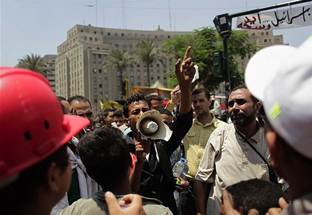 Opponents of Egypt's ousted Islamist President Mohammed Morsi chant slogans against the Muslim Brotherhood at Tahrir Square in Cairo Saturday, July 6, 2013. Egyptians were on edge Saturday morning after supporters and opponents of ousted President Morsi fought overnight street battles that left at least 30 dead across the increasingly divided country.