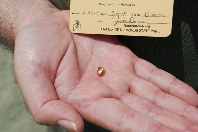 Terry Staggs of Richmond, Ky. holds the 2.95-carat champagne-brown diamond he found July 4, 2013 at the Crater of Diamonds State Park in Murfreesboro. This is the largest diamond found at the park so far this year, officials said.