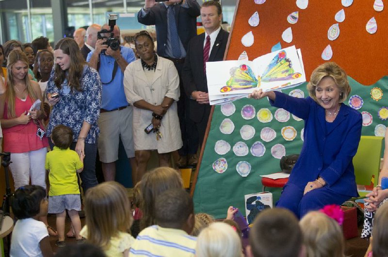 Former Secretary of State Hillary Rodham Clinton reads The Very Hungry Caterpillar to children Monday at a ceremony renaming the new children’s library in Little Rock in her honor. 
