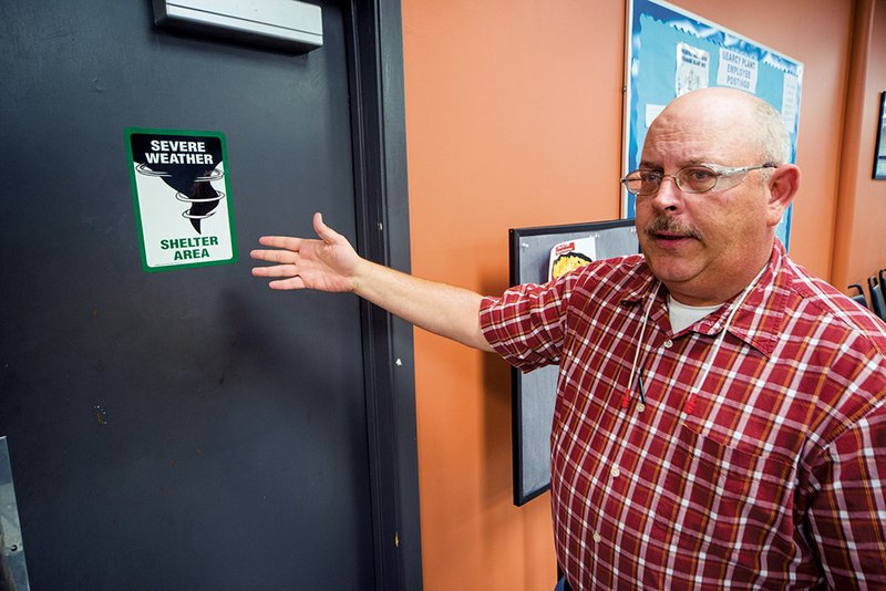 Kevin Caldwell, environmental health and safety manager for the Eaton Corp. hydraulics plant in Searcy, points out one of the storm-shelter areas in the factory.