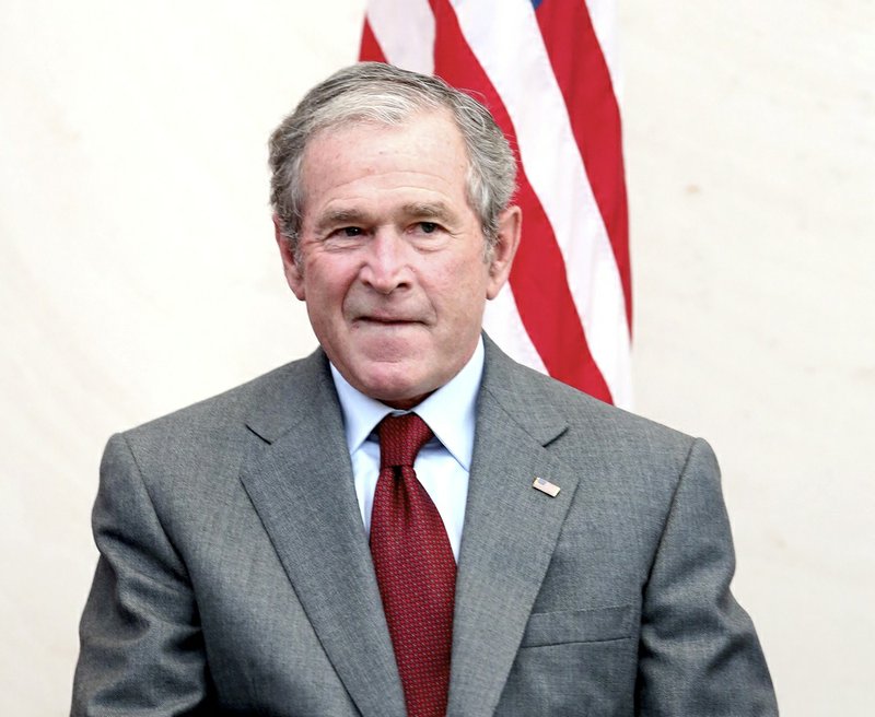 Former President George W. Bush bites his lip after giving a speech before a U.S. citizen swearing in ceremony at the The George W. Bush Presidential Center in Dallas on Wednesday, July 10, 2013. 