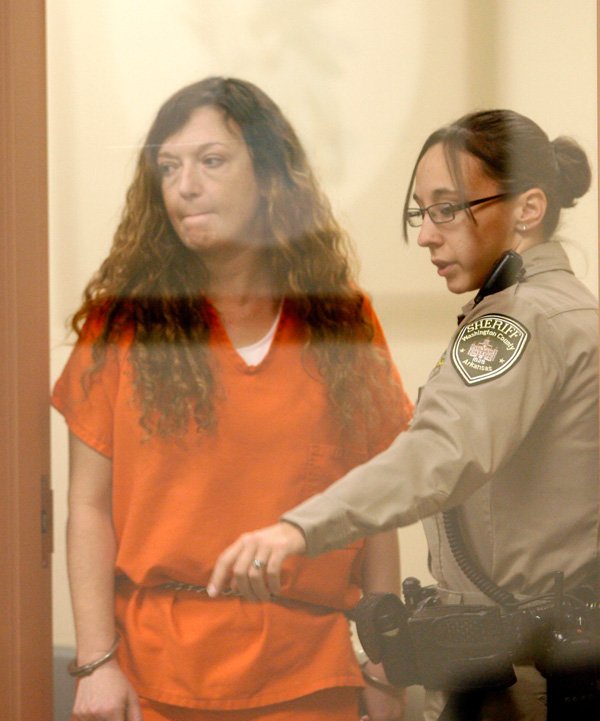 Heather Swain is led into the courtroom Jan. 30 at the Washington County Detention Center in Fayetteville for arraignment with Judge Ray Reynolds. 