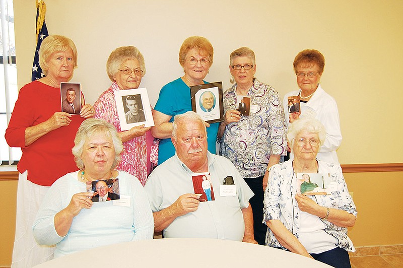 Some members of the THEOS group in Benton gather, carrying pictures of their late spouses. The organization, sponsored by Roller-Ballard Funeral Homes, provides support and social activities for widows and widowers. Seated, from the left, are Wanda Cody, Andy Alpe and Alita Cockman. Standing, from the left, are Shirley Laster, Nell Low, Becky Townsend, Gerry Goodin and Betty Ford. 
