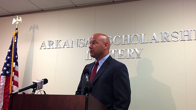 Arkansas Lottery Commission Director Bishop Woosley speaks at a press conference Friday, July 12, 2013, at the commission's offices in downtown Little Rock to discusses the theft of lottery tickets by former deputy director of security Remmele Mazyck.