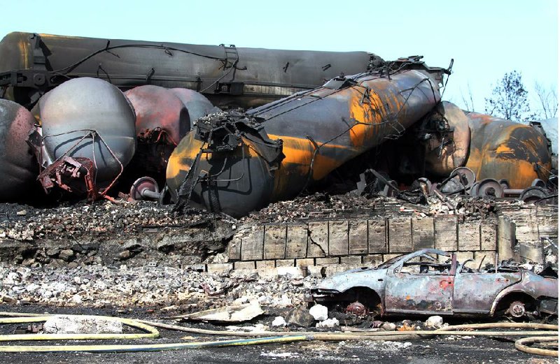 Wrecked tanker cars and debris from a runaway train sit in Lac-Megantic, Quebec, after the train derailed, igniting rail cars carrying crude oil on July 6. The catastrophe, in which dozens were killed, has renewed calls to retrofit a certain type of rail tanker. 