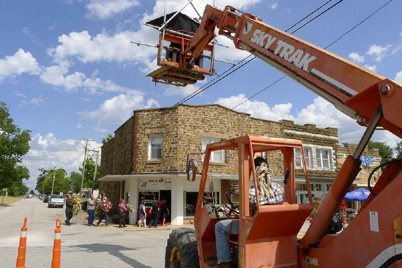 Arkansas Democrat-Gazette/Bill Bowden Fimmakers shoot a scene Wednesday in Hindsville for the movie Valley Inn. In this scene, mourners are walking from a funeral back to the Valley Inn Cafe.