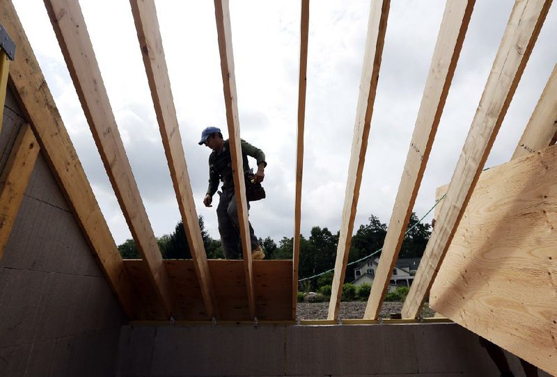 A worker installs a roof on a new house in New Paltz, N.Y., on July 9. Homebuilder confidence in demand for new homes rose more than forecast this month. 