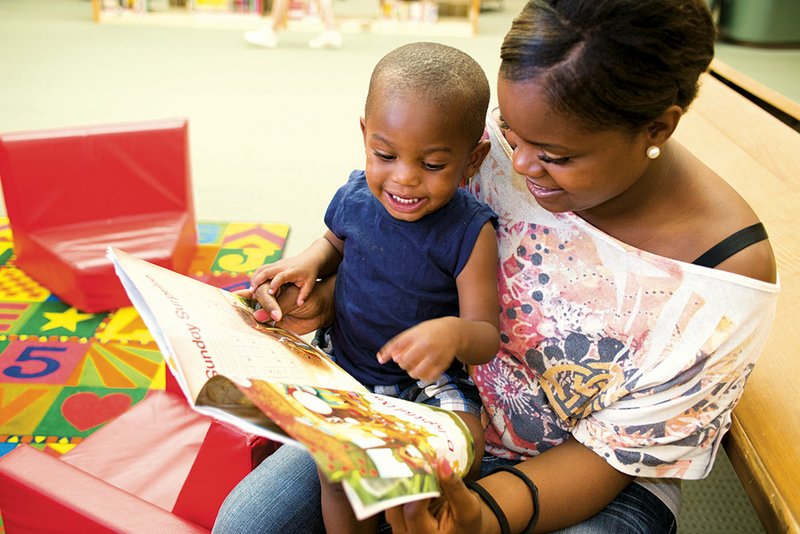 Shanae and Isaiah McDonald, 1,  read a story together at the Faulkner County Library.