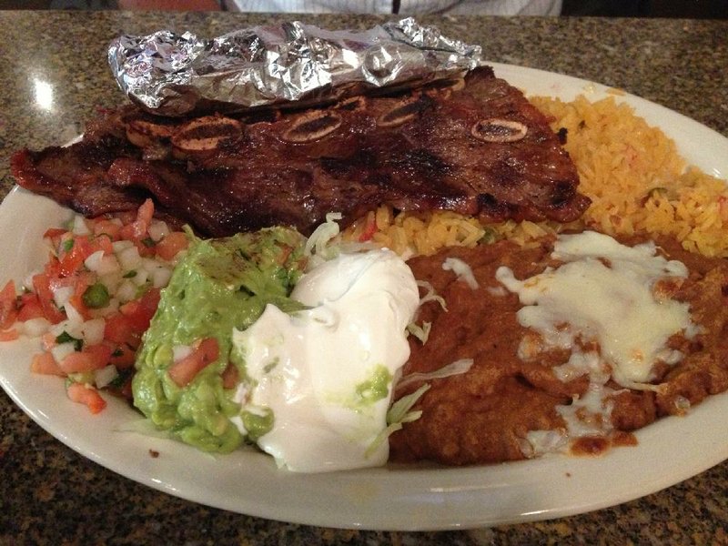 The Costillas Marinadas includes four marinated ribs with rice, refried beans, salad and tortillas at Cantina Cinco de Mayo in west Little Rock.

