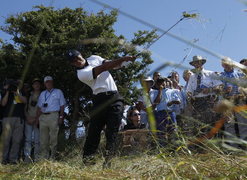 Tiger Woods of the United States plays out of the rough on the first fairway during the first round of the British Open Golf Championship at Muirfield, Scotland on Thursday.