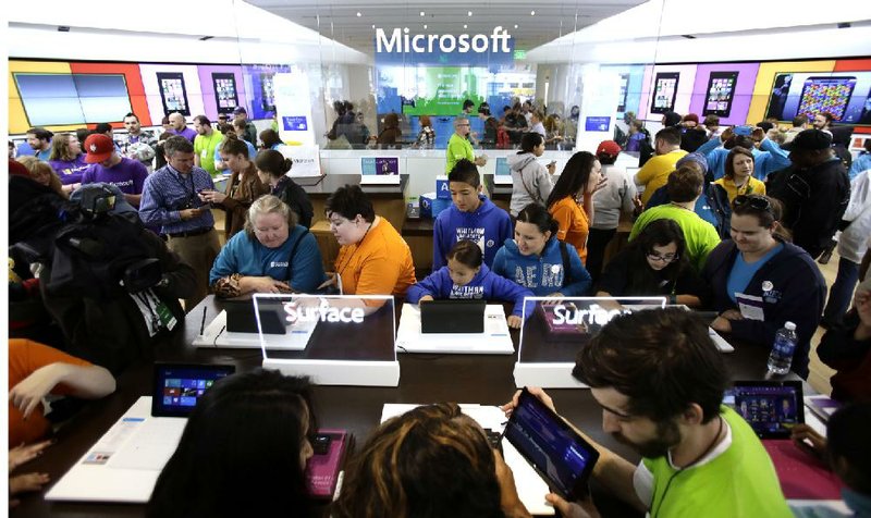 A crowd fills a Microsoft retail store in Portland, Ore., in June. The software company on Thursday reported a quarterly profit of $4.97 billion. 