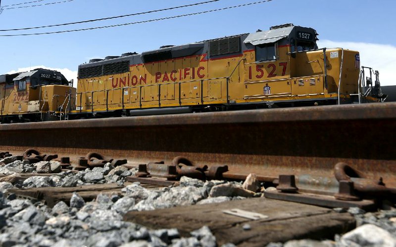 A Union Pacific engine idles Monday in a rail yard in Phoenix. Union Pacific Corp. said Thursday that rate increases helped lift its second quarter profit to $1.11 billion. 
