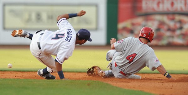 Northwest Arkansas Naturals second baseman Angel Franco, left, loses the ball and his glove as Springfield right fielder Adam Melker slides in safely to steal second base during the third inning Thursday, July 18, 2013, at Arvest Ballpark in Springdale.