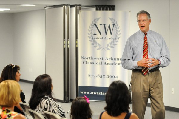 Timm Petersen (cq), headmaster of the Northwest Arkansas Classical Academy, talks to parents and students about the education kids will receive at the charter school July 18, 2013, at the school's location at 1302 Melissa Drive in Bentonville. The school will open as a kindergarden through eighth grade school with room for 445 students.