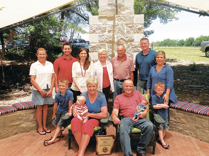 The Glen Hill family of the Manchester community has been named the 2013 Clark County Farm Family of the Year. Jacque and Glen, seated, center, hold their youngest grandsons, Rhys Wheaton, 4 months, and Thomas Hill, 7 weeks. Also pictured are their grandsons Zane Hill, 7, and Ben Hill, 4. Other family members include, back row, from the left, Carol Morgan, Cary and Kristyn Wheaton, Barbara and Virles Wasson and Kurt and Elizabeth Hill. See related story on Page 3T.