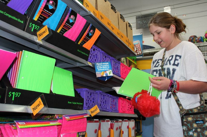 Lexie Cox looks at school supplies Friday at the Wal-Mart Supercenter on Mall Avenue in Fayetteville as she anticipates her ninth-grade classes at Ramay Junior High. 